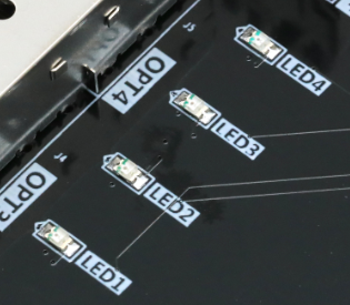图片内容：图片显示了AX7325B开发板上的四个LED灯（LED1、LED2、LED3、LED4）的实物图。每个LED灯都标有相应的编号，LED1位于左上角，LED2在右上角，LED3在左下角，LED4在右下角。LED灯的引脚通过焊接连接到开发板上。 图片作用：这张图片是用户手册中关于LED灯实物图的示例，用于直观展示开发板上LED灯的实际位置和布局，帮助用户更好地理解和连接硬件。