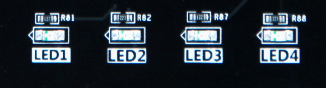 图片展示了开发板上四个LED灯（LED1至LED4）的实物图，每个LED灯旁边都有一个编号和一个箭头指向，分别对应硬件设计示意图中的R01至R04。图片在文档中用于直观展示LED灯在扩展板上的实际位置和布局，帮助用户更好地理解硬件连接。